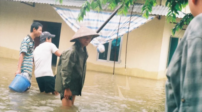 Người dân lội nước lũ ngập sân nhà